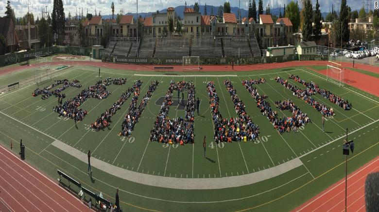 At Granada Hills Charter High School in Los Angeles, students lay down on a football field to spell out the walkouts rallying cry: Enough.