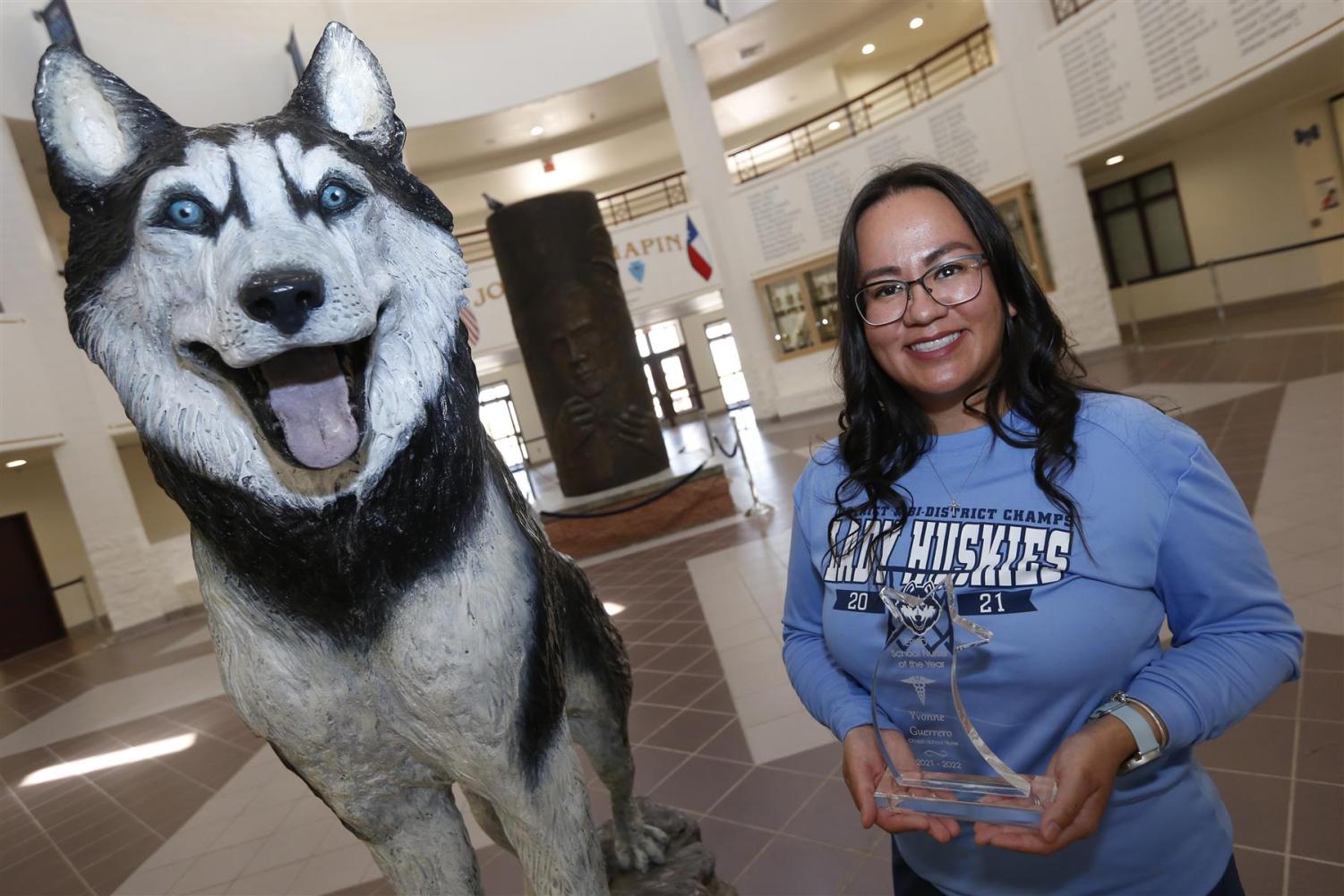 Nurse Guerrero poses with her district award representing the Huskies.