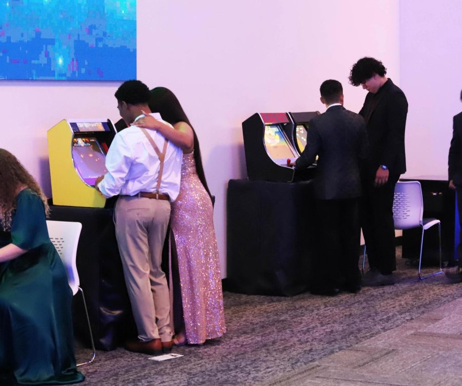 People using the arcade at the dance
