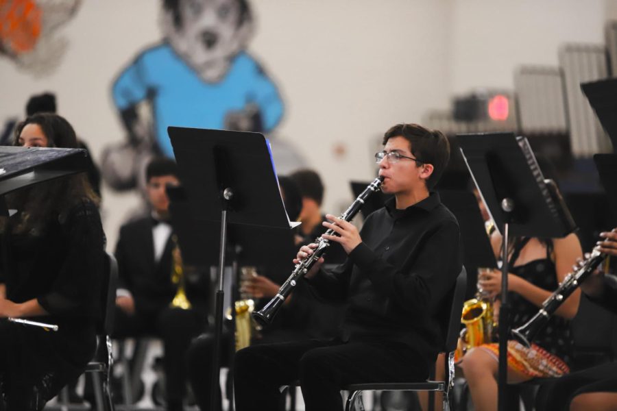 Trace Mckissack playing the clarinet in the first row during the first song of his last performance of this year. Chapin Gym, May 16, 2022.