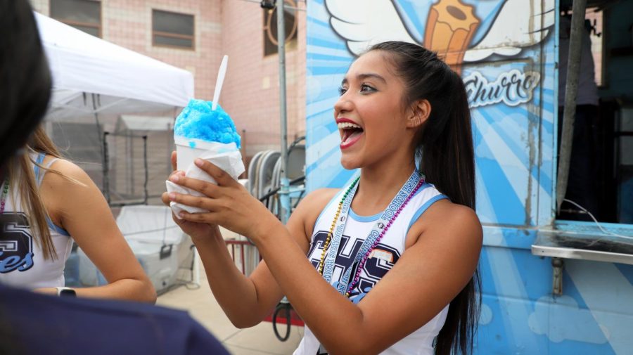 Junior Savannah Zamora shows a big smile as she receives a sno-cone from  the ice cream truck in the courtyard.  
