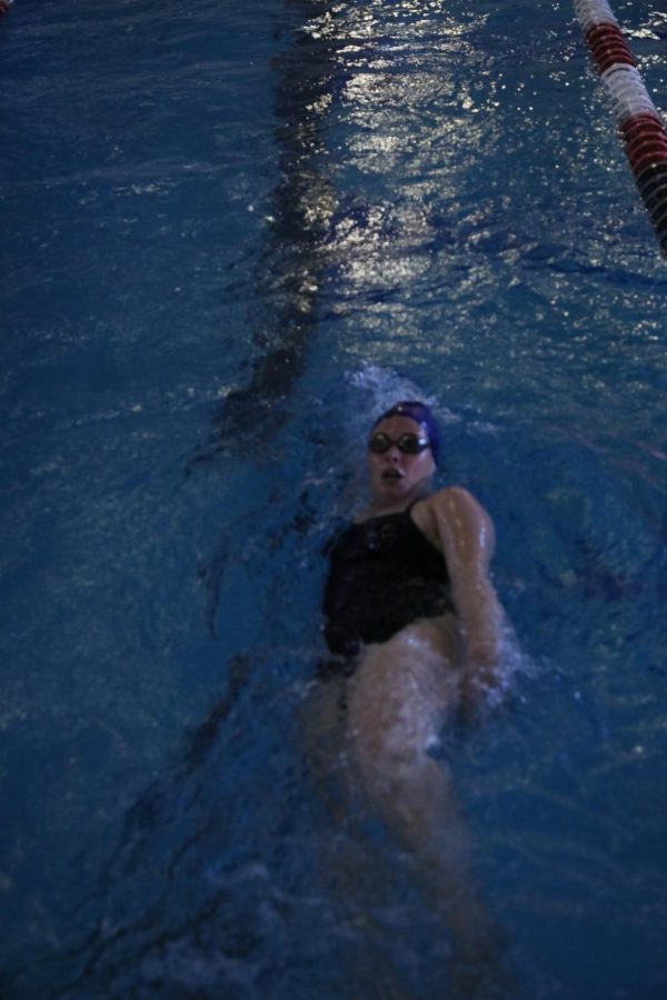 Senior Kylea Goldberg  on the way to finishing the 100 womans backstroke.