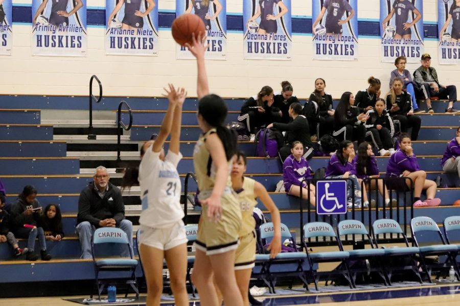 sophomore Isa Armijo shooting a 2 while being guarded and making it.