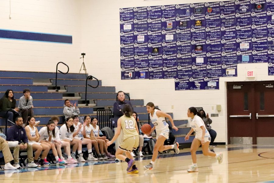 Sophmore Alejandra pineda dribbling the ball down the court.