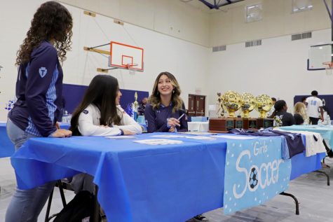 Sophomore soccer player Aleece Frede laughs with teammates Valeria Contreras and Stephenie Aguilera while waiting fro the eighth graders. All three girls are on the varsity squad and received 30 signatures from eighth grade girls interested in joining the team. 