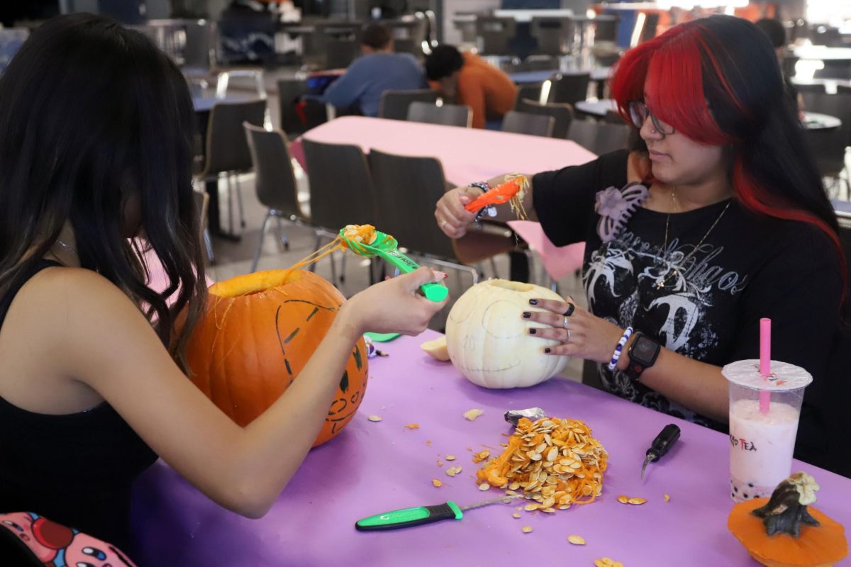 Moving on to the second step, Myla Tarin and Aviona Delgado empty their pumpkin before carving out their designs.