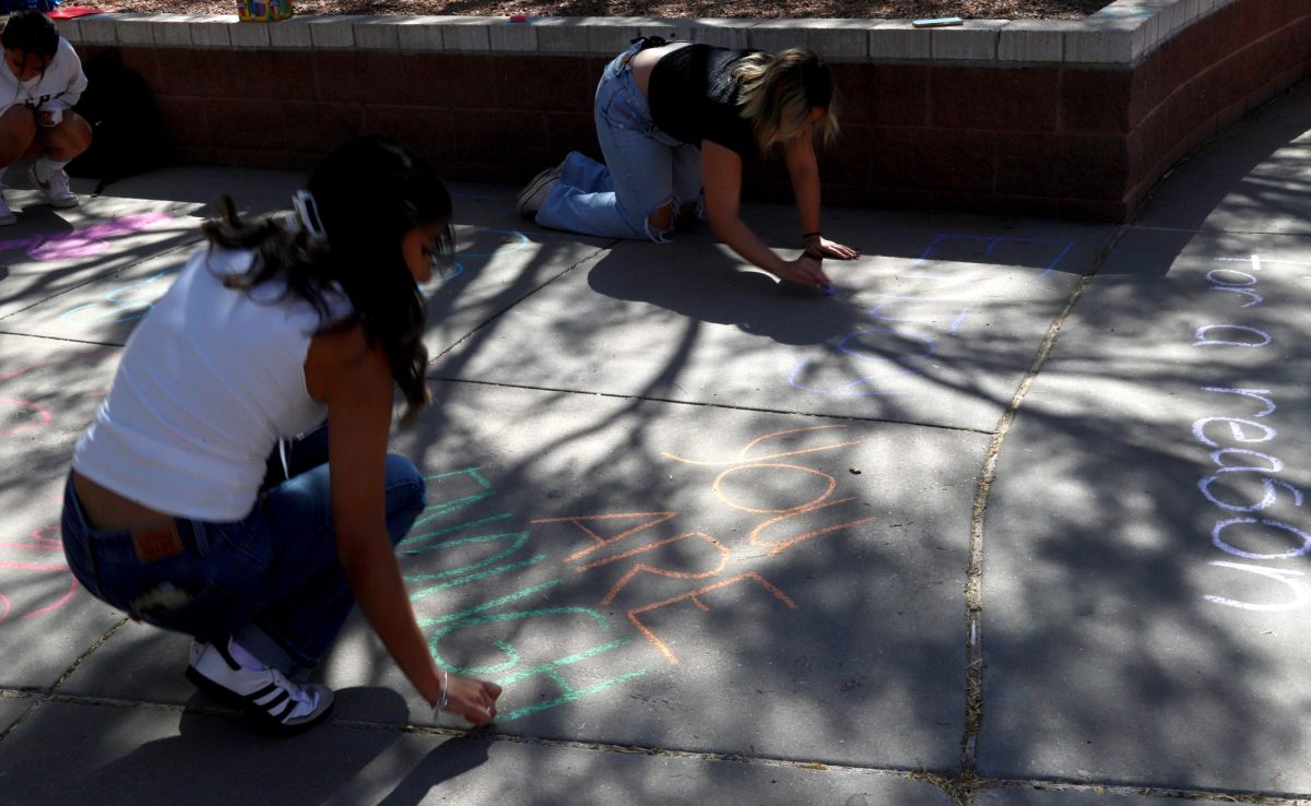 Students prepare designs for the postponed Chalk It Up event, which was moved to May 19 because of rainy weather conditions. 