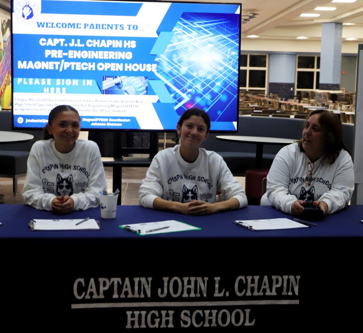 Welcome.
As the guest came into the school for the open house everyone at this table was saying welcome. They got the guest signed in then sent them off with tour guides to enjoy the event. Scarlet Molinar in the middle said "I enjoyed being at the welcome table because we got to make jokes with the parents, make them laugh before they go in."