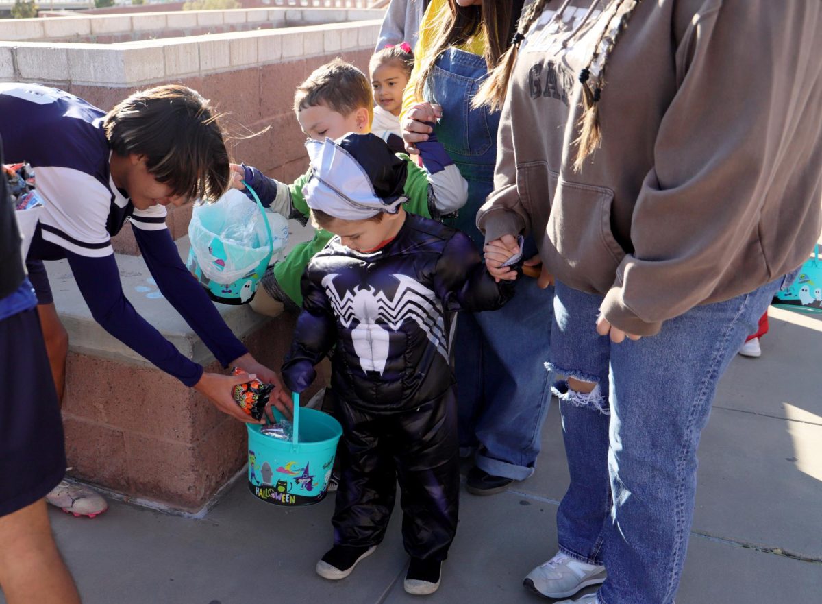 Trick-or-treaters on the run! The kids ran excitedly outside to go get candy from the soccer players. "Here there's plenty of candy for you" said  Aiden Bravo