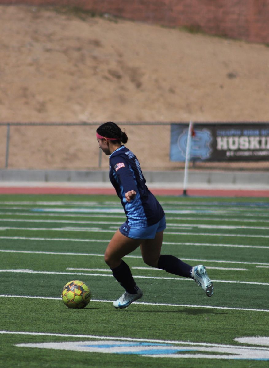 Junior Stephine Aguilera has ball in play determined to take the next shot at a goal. 