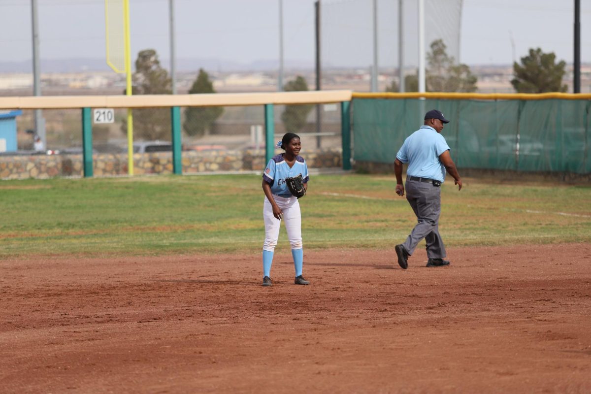 Player is down and ready at second base waiting for if the ball comes her way
