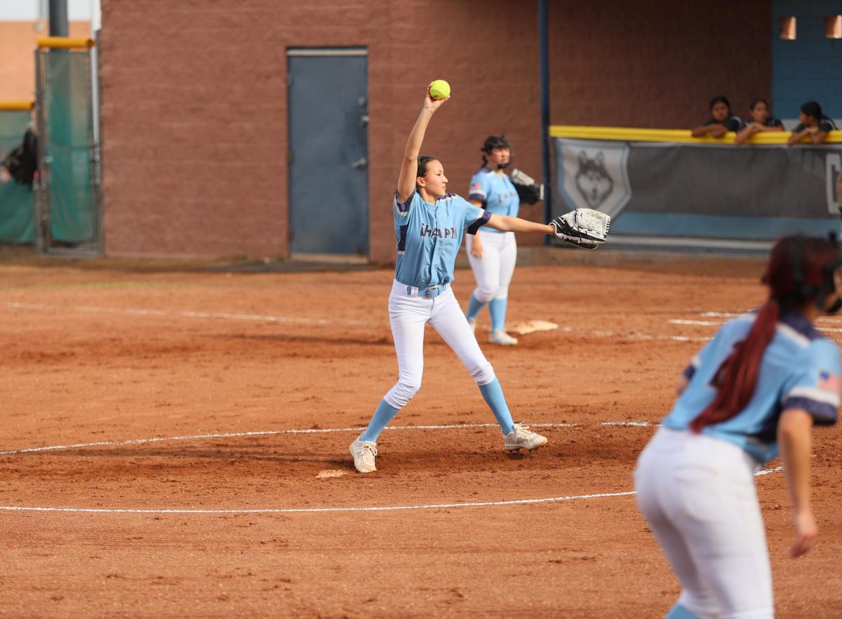 pitcher is in full swing! getting ready to try and strike out her opponent