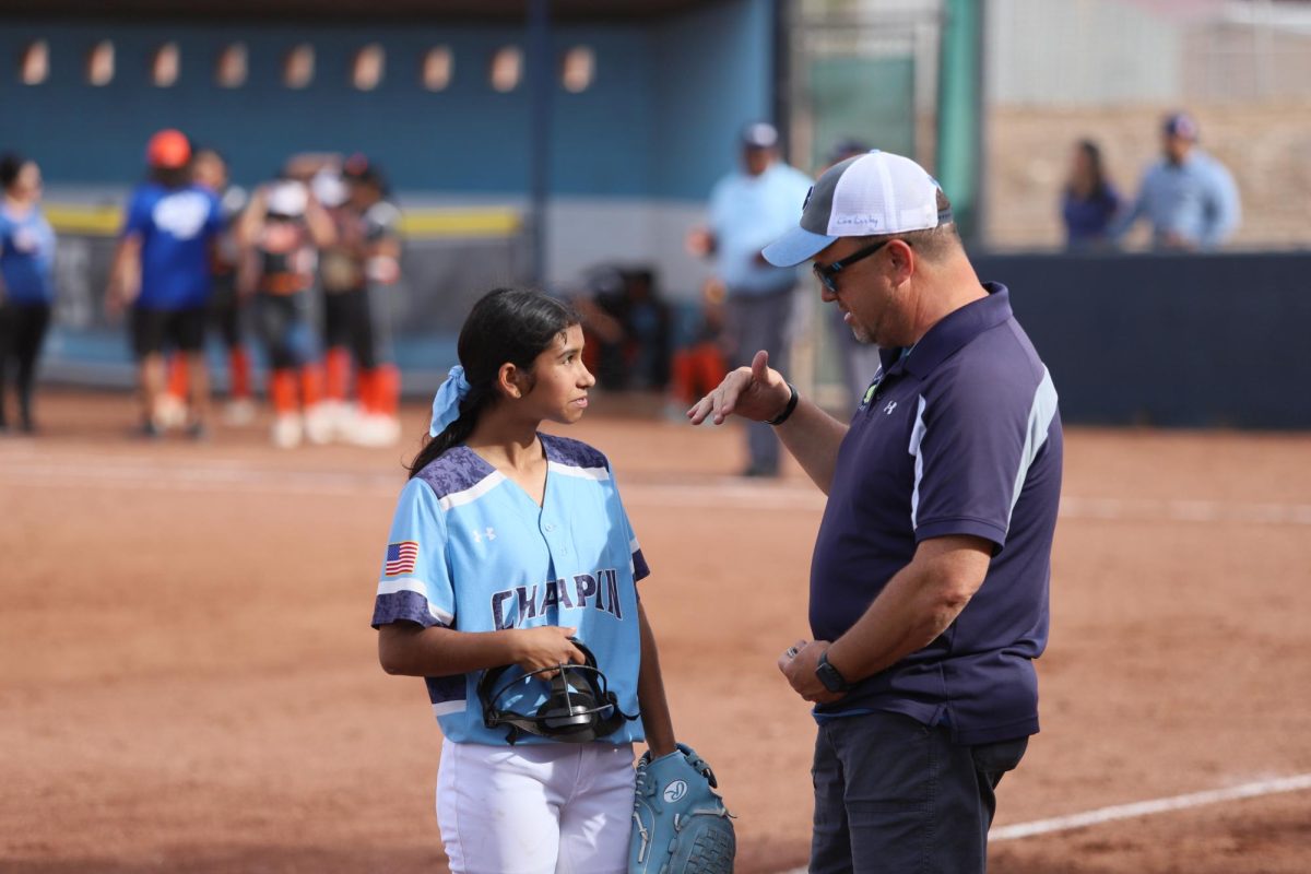 Player talks to coach after their first inning