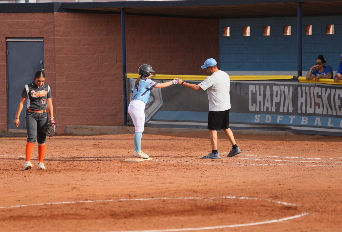 player makes it to first and fist bumps coach