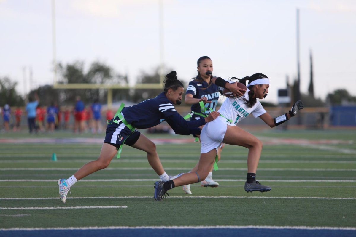 Sophomore Jizelle Varela runs after the ball to get the girls flag. She took the flag off to stop the play. " That was my first time on defense, but it hurt falling after getting her flag," Jizelle said. 