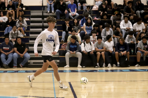 Dribbling the ball down the court is senior Logan Zimmer. He got the ball in the defensive side of the field and brought it into the attack.  