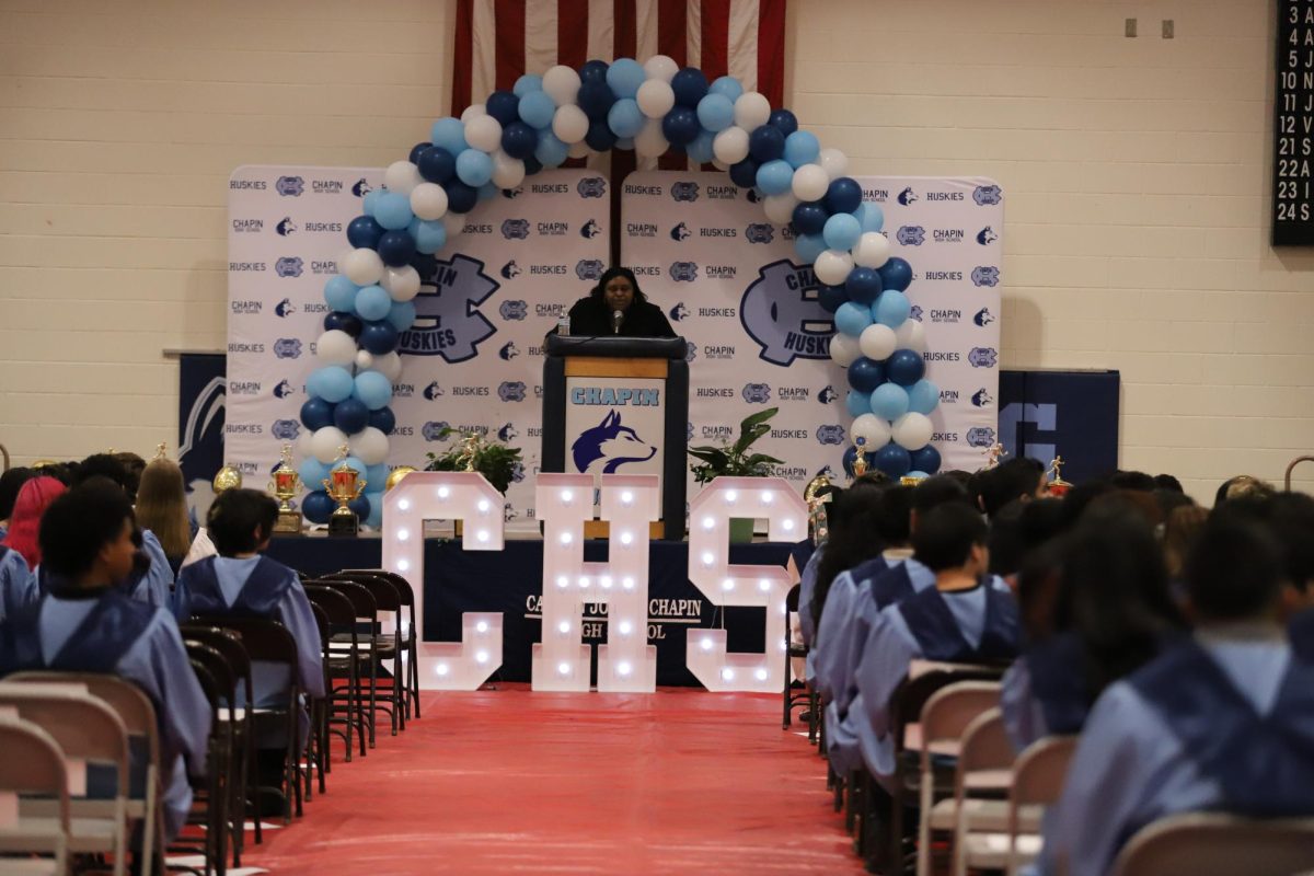 Principal Reagan Chappell announces the names of each student recognized. "The principal should announce the names of each senior to let them know that we recognize and appreciate their accomplishments," said Chappell, "no matter how tiring it is, how my voice cracks, I wanna read every single seniors name."