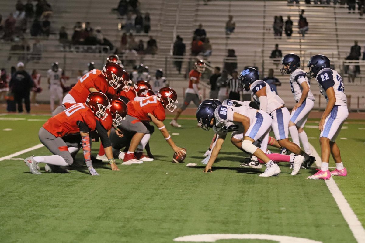  Lined up!
Jv football lines up against Jefferson high school during Thursday night’s game. Players from both teams prepare for the snap at the line of scrimmage under the stadium light. 