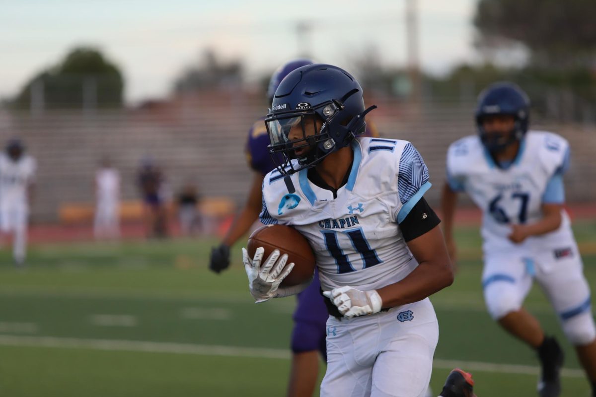 Jeshua (number 11) running with the football towards a touch down. GO CHAPIN! Jeshua said "I Just ran"