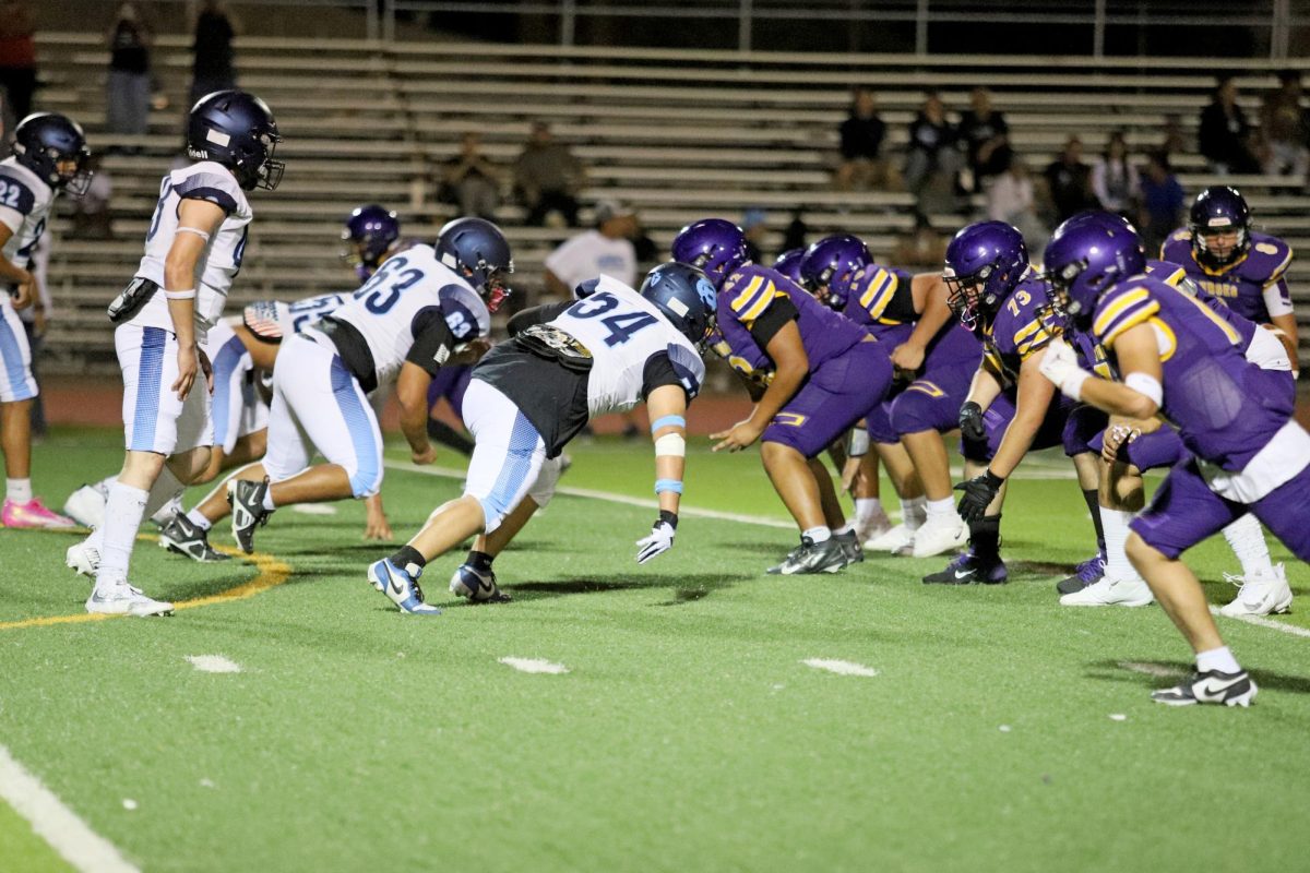 Focus returns to the field 
 JV players take their positions for the upcoming play against Burges High School. They regrouped quickly after the previous play to stay ready for the next one. 

 