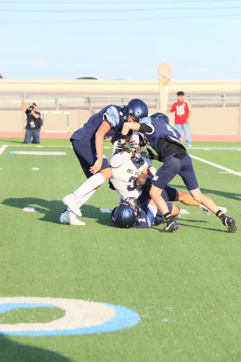 Freshmen Liam, Sean, and Sebas tackle opponent together to stop a 15 yard run. 