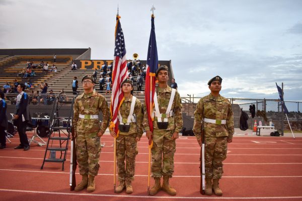 The Chapin Color Guard stands at attention before coming onto midfield for the singing of the national anthem.