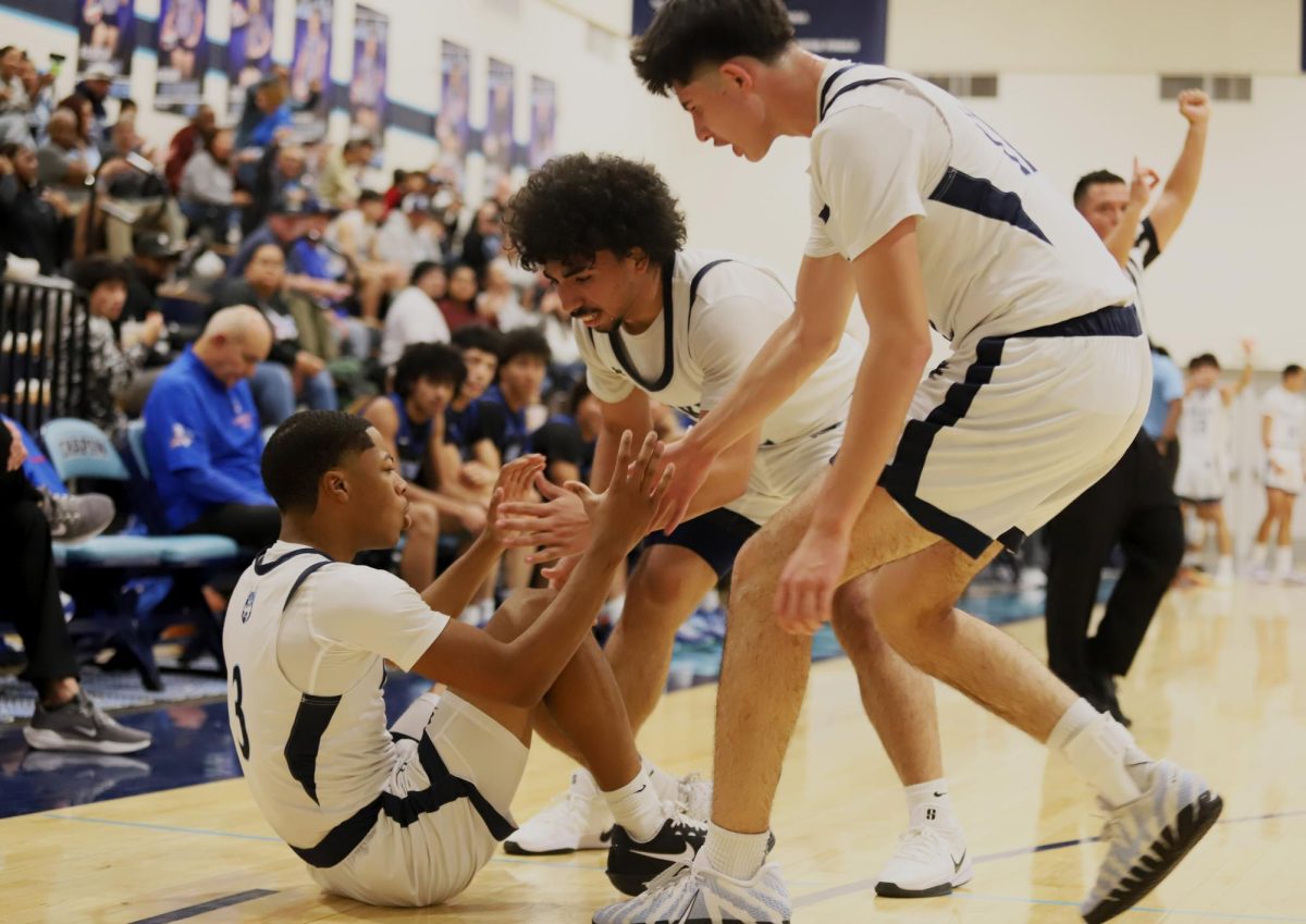 After going to the flor, bryson #3 is helped up by his teammates. " We pick each other up and keep playing" Bryson said.
