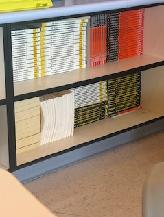 Books line the shelves in a classroom where students and parents continue to reflect on how grades shape learning, motivation, and stress.