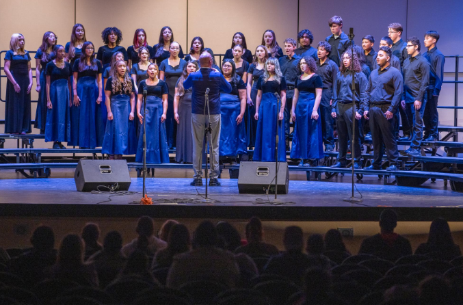 Eric Weaver conducts the choir during the Nov. 19 performance, guiding singers as they perform together on stage. 