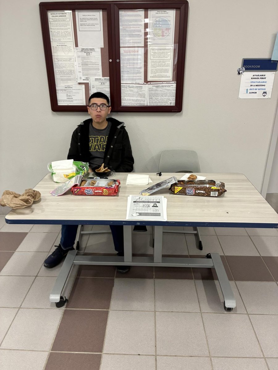 Leadership student handing out Chips Ahoy cookies to seniors as a sweet reward for ordering their cap and gown.