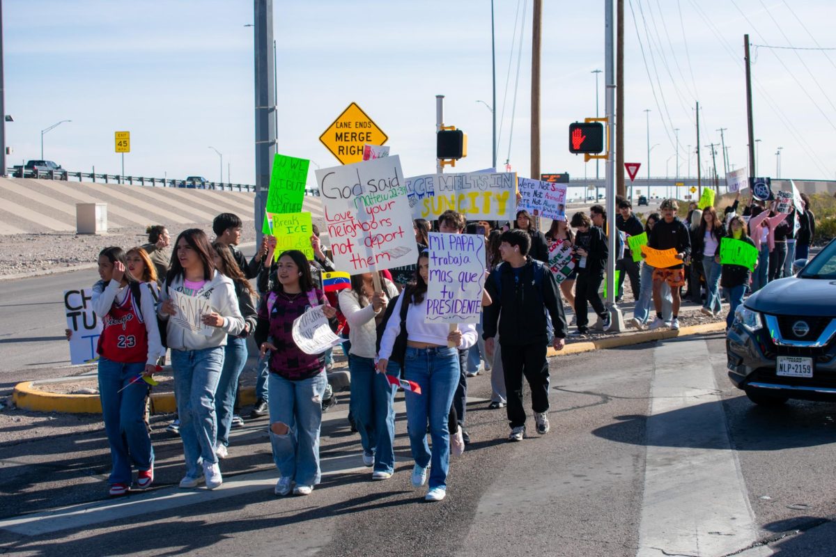 Students continue moving down Dyer waving anti-ICE signs