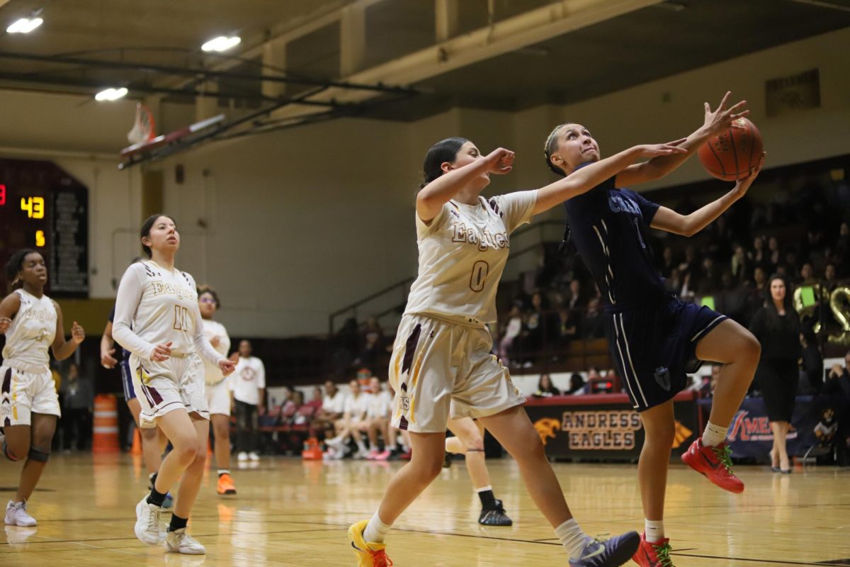 All in. Player in blue goes for the shot while opposing player tries to block her. jizelle Varela  makes the shot and her team celebrates. "We just had a lot of great communication and passing and we were getting our shots up."