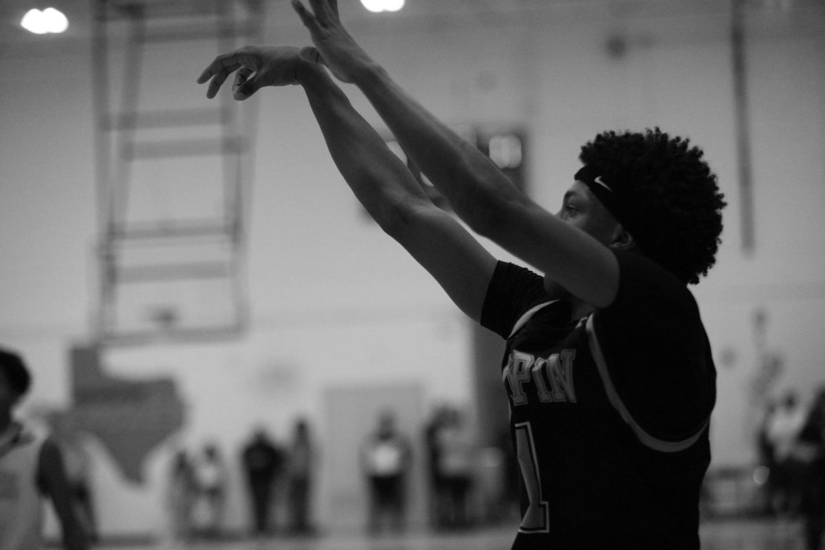BOOM. In this photo guard Keymani Oxendine is seen shooting a corner three. Keymani made this three giving the huskies more momentum going into half time. "Being able to shoot and dribble really makes Keymani a big threat" Freshman beskatball player Thomas Comacho said.