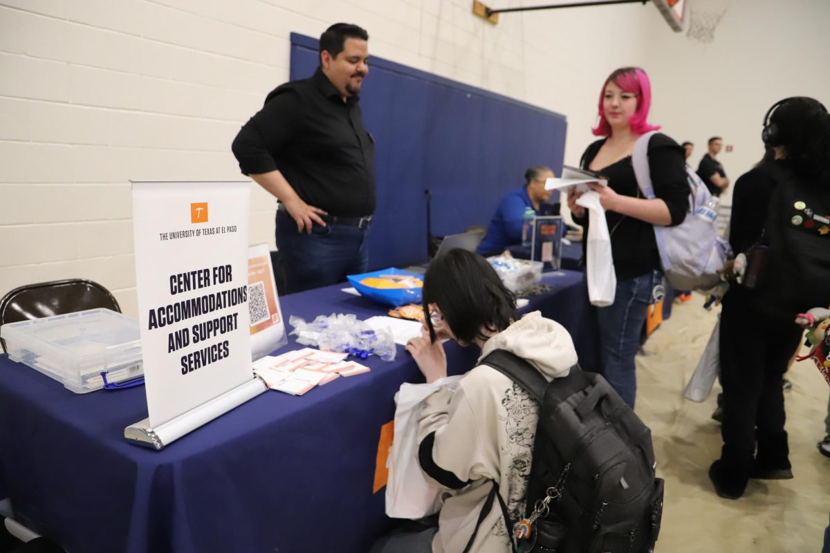 Planning for future. A college representative speaks about admissions and academic programs. Students sign up for services they take interest in.