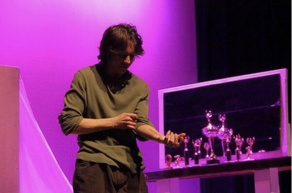 Facing his past. Senior, Elijah Lemmon portrays character Conrad Jarret as he reveals a scar. Earlier in the play, Conrad avoided discussing his suicide attempt, making this scene a turning point on his journey to healing.